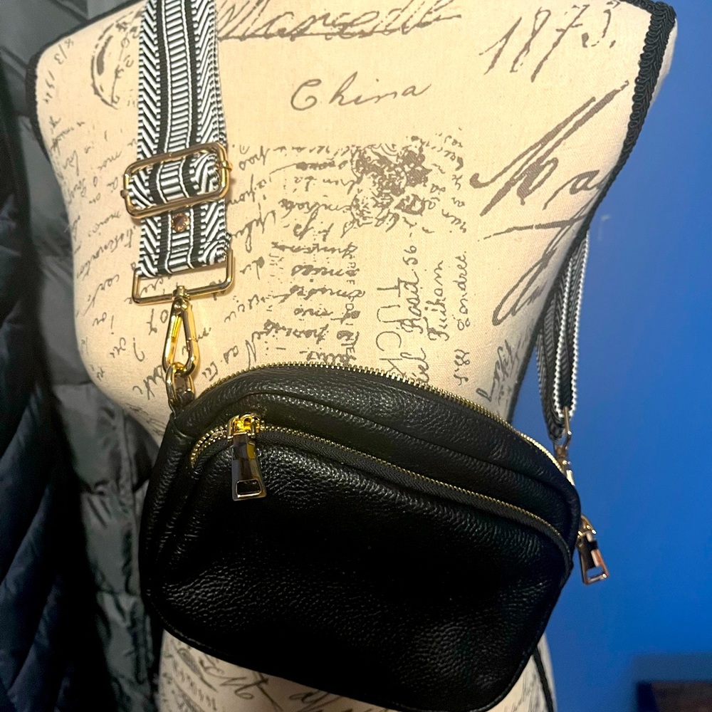 Pom Pom London leather black crossbody w/ black and white strap.